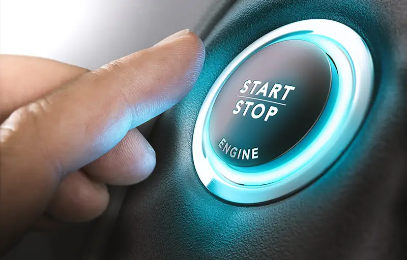 Person pressing an engine start button