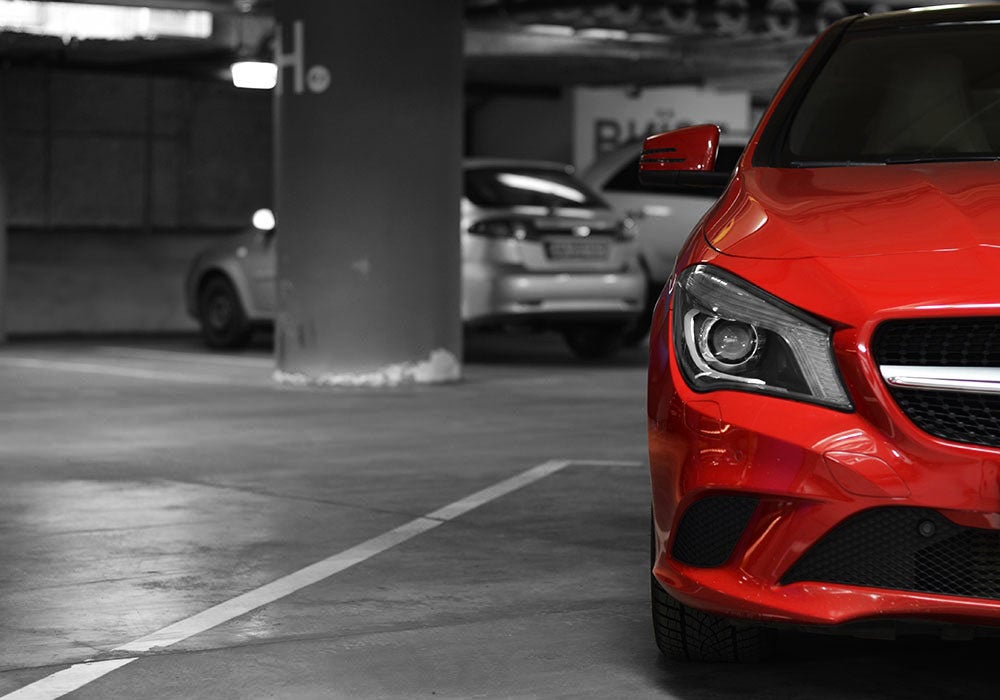 A red car parked in a parking garage