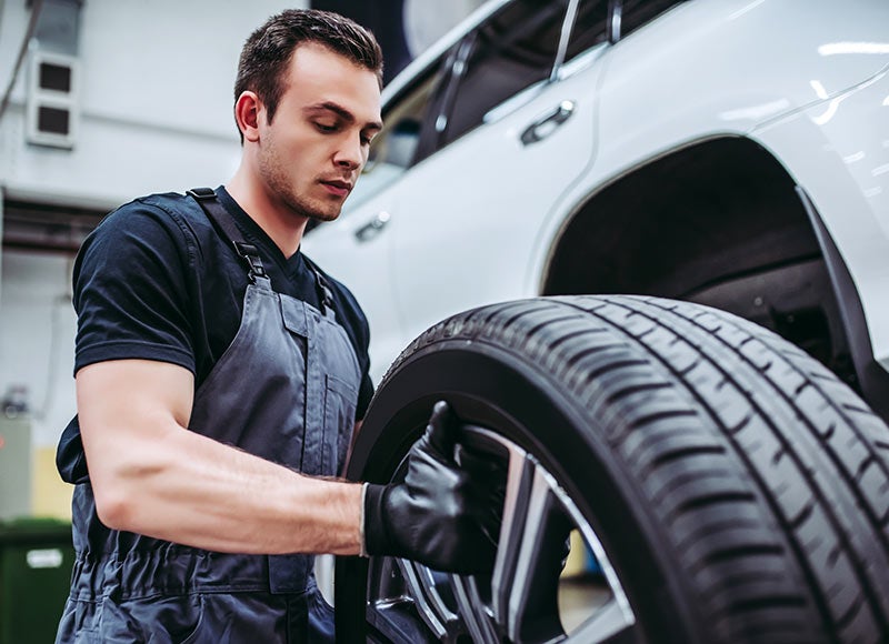 a service tech replacing a tire