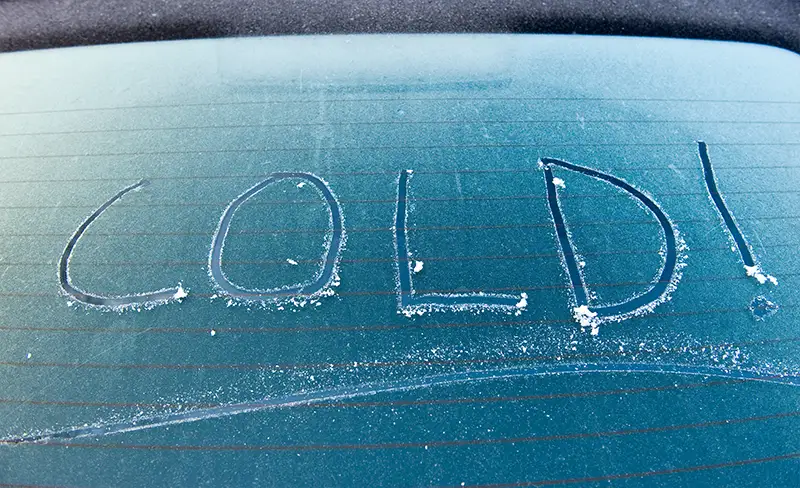 windshield with the word cold in the frost
