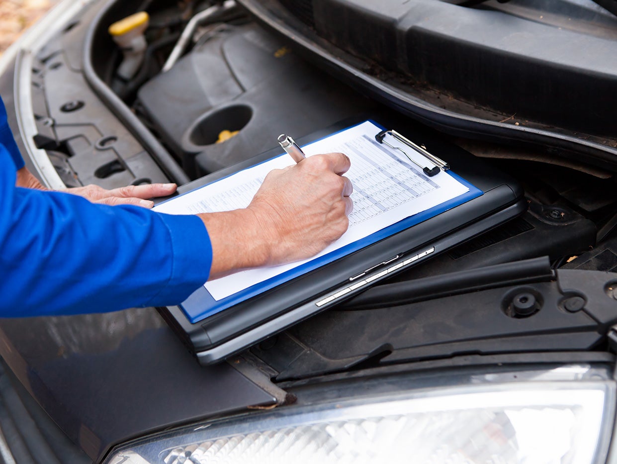 A service technician takeing notes on a clipboard